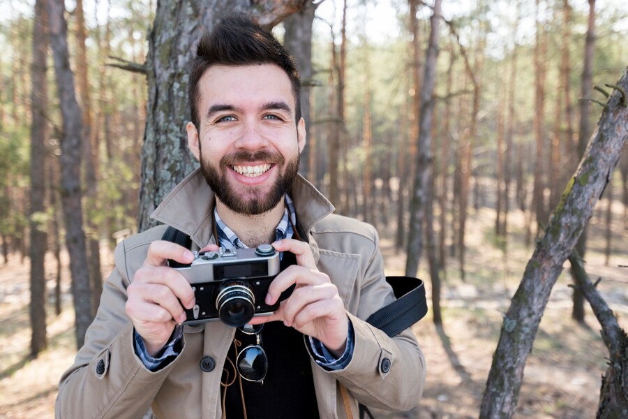 portrait smiling male hiker holding-camera