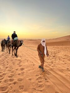 Camel riding in sahara desert